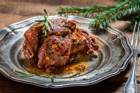 Metal plate of baked venison with rosemaryの写真素材