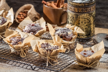 Chocolate muffins with nuts and icing sugarの写真素材