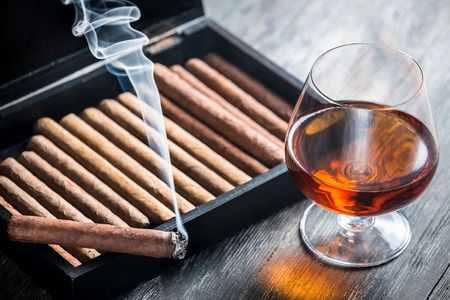 Burning cigar and cognac in glassの写真素材
