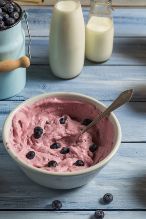 Whipped cream and fresh blueberries as ingredients for ice creamの写真素材