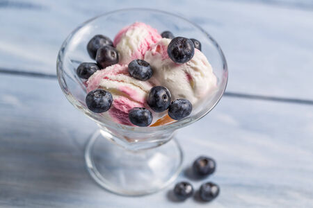 Bowl with ice cream and fresh blueberryの写真素材