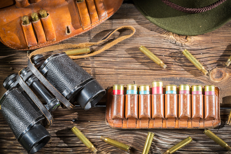Belt with hunter bullets and binocularの写真素材