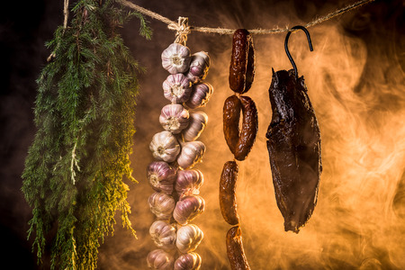 Ham, sausage and garlic in a homemade smokehouseの写真素材