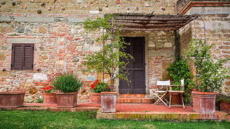 Beautiful porch in front of an old house in Tuscanyの写真素材