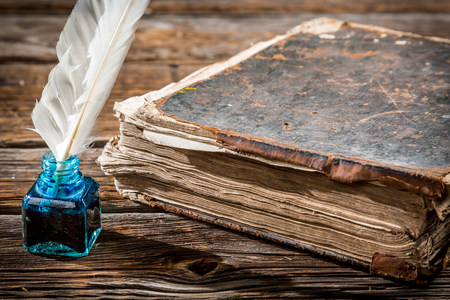 Old big book and pen with blue inkの写真素材