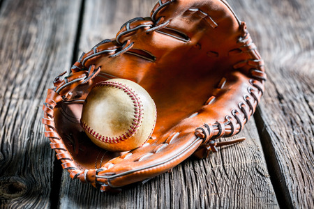 Old baseball glove and ballの写真素材
