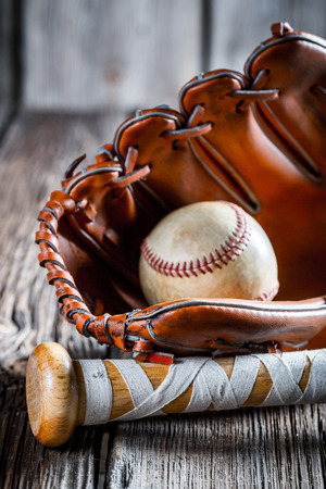 Old baseball bat and glove with ballの写真素材