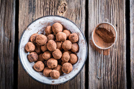 Chocolate balls in a white bowlの写真素材