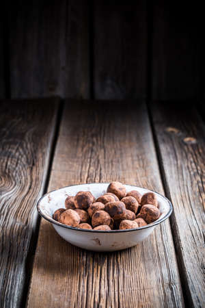 Chocolate balls in a old white bowlの写真素材