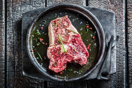 Closeup of beef with rosemary and pepper ready for grillingの写真素材