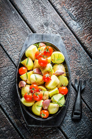 Potato with fresh tomato and garlic ready for grillingの写真素材