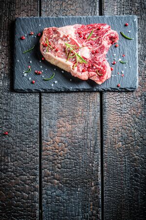Beef with fresh herbs on black rockの写真素材