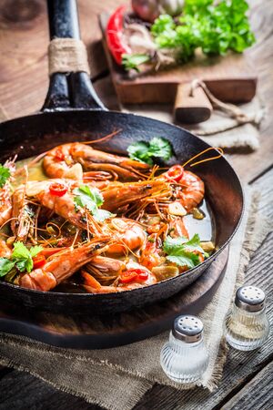 Fried king prawns with garlic and red peppersの写真素材
