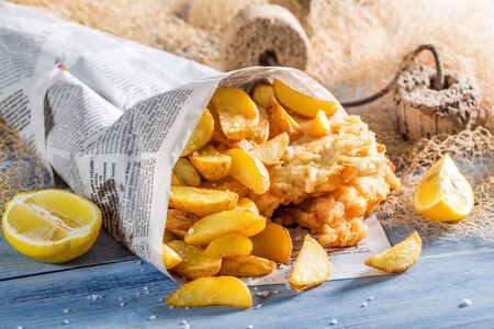 Homemade fish and chips in newspaper