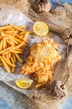 Hot fish cod with chips served in paperの写真素材