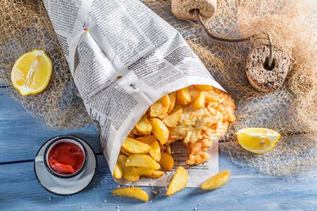 Homemade fish and chips served in paperの写真素材