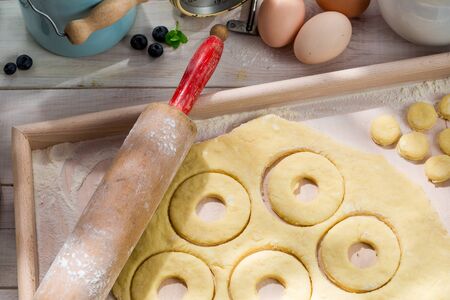 Preparation for delicious donuts in the sunny kitchenの写真素材