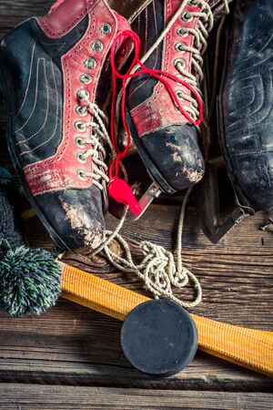 Old various skates on old wooden table