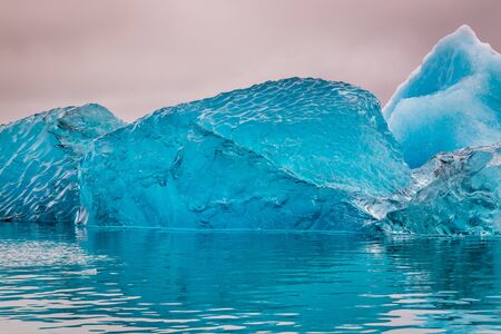 Blue iceberg just after flipping in water, Icelandの写真素材