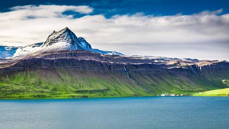Volcanic mountain over fjord in Icelandの写真素材
