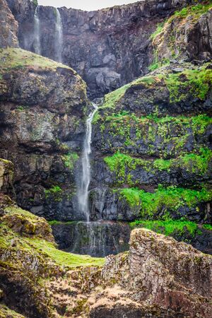 Small waterfall in the mountains in Icelandの写真素材