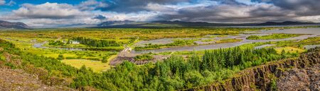 Panorama of green valley with the river and the mountains in Icelandの写真素材