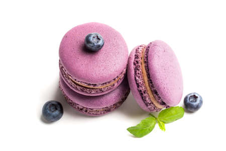 Tasty macaroons with blueberries on white backgroundの写真素材