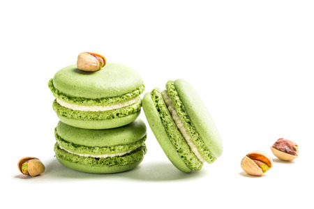 Sweet macaroons with pistachio on white backgroundの写真素材