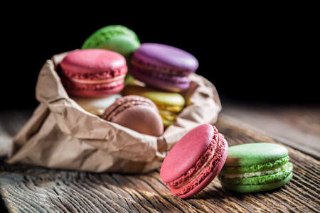 Colorful macaroons in paper bagの写真素材