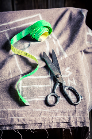 Sewing table with scissors and clothの写真素材