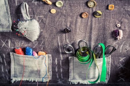 Old sewing cloth with scissors, threads and needles in tailor workshopの写真素材