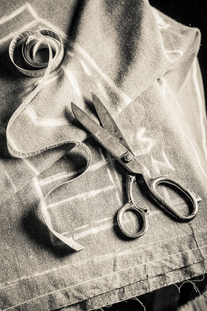 Old sewing table with scissors, cloth and tailor tapeの写真素材