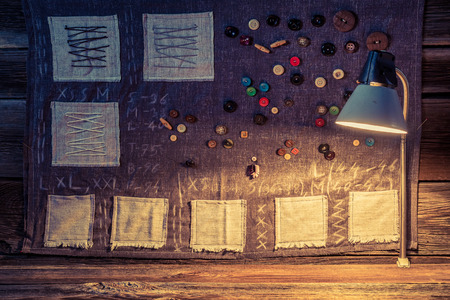 Sewing cloth made of needles, threads and buttons in tailor workshop