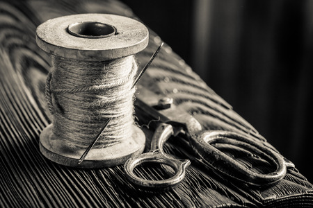 Vintage sewing table with scissors, threadsの写真素材