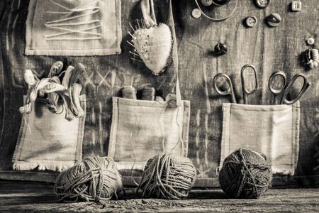 Vintage background made of threads, needles and buttons in tailor workshopの写真素材