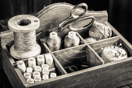 Vintage threads, needle and scissors on tailor tableの写真素材