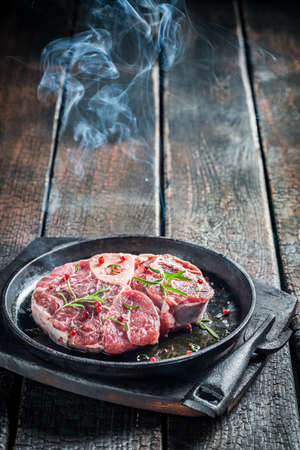 Grilling beef with rosemaryの写真素材