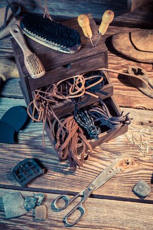 Shoemaker workplace with tools, leather and shoesの写真素材