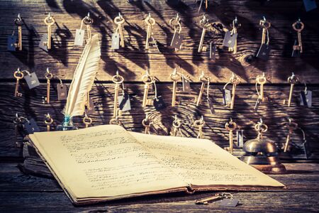Vintage reception in hotel with keys for rooms and guestbookの写真素材