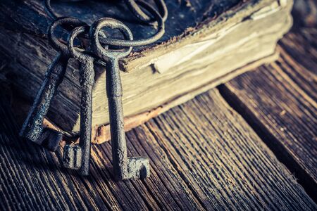 Vintage keys and books on old wooden tableの写真素材