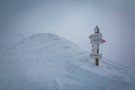 Snowy signpost at the summit of Kasprowy Wierch, Tatra Mountains, Polandの写真素材