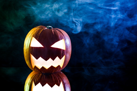 Smoking pumpkin with candle and smoke for Halloweenの写真素材