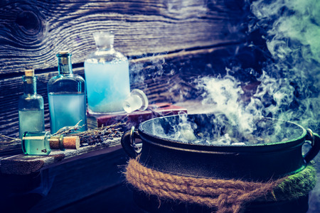 Old witch pot with blue potions for Halloweenの写真素材