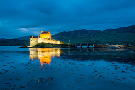 Stunning illuminated Eilean Donan Castle at dusk, Scotlandのeditorial素材