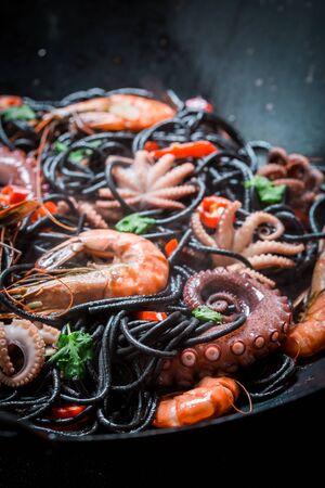 Enjoy your spaghetti with seafood with shrimp, octopus and parsleyの写真素材