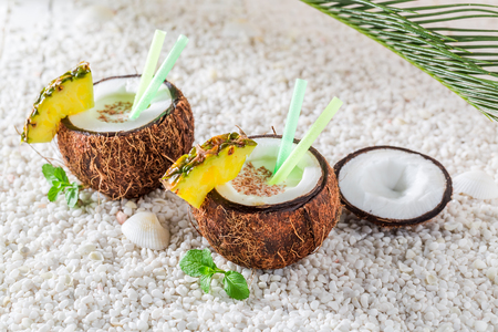 Tropical pinacolada in coconut in sunny dayの写真素材