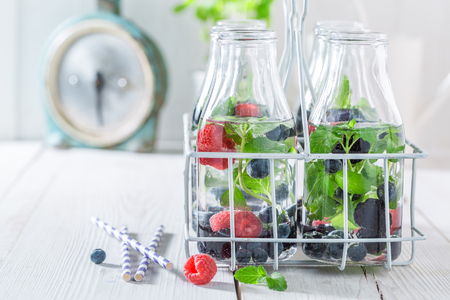 Fresh water in bottle with berries and mint leavesの写真素材