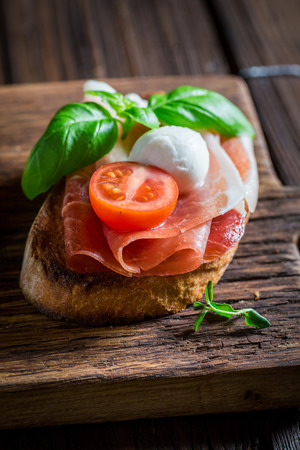Delicious mix of bruschetta with fresh ingredients for breakfastの写真素材