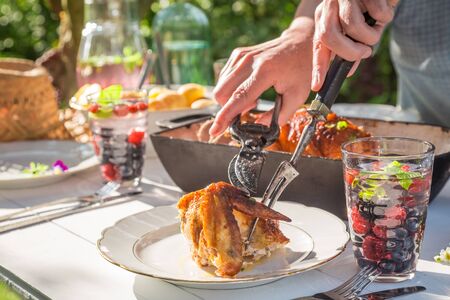 Tasty dinner with chicken and potatoes served in the gardenの写真素材