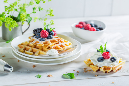 Delicious and sweet waffles with berry fruits and whipped creamの写真素材